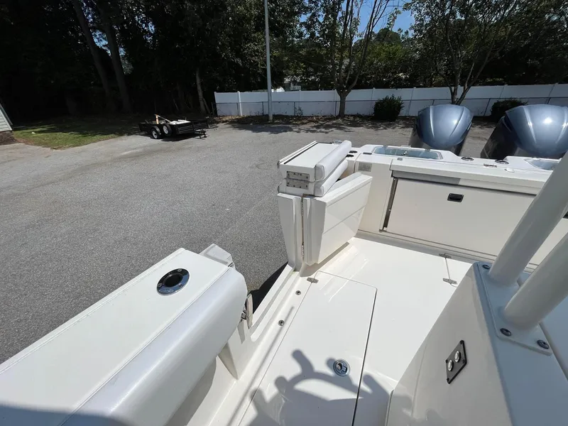 Slide: The Image of 2019 Cobia 320 CC boat interior, featuring sleek design and dual engines. - 14