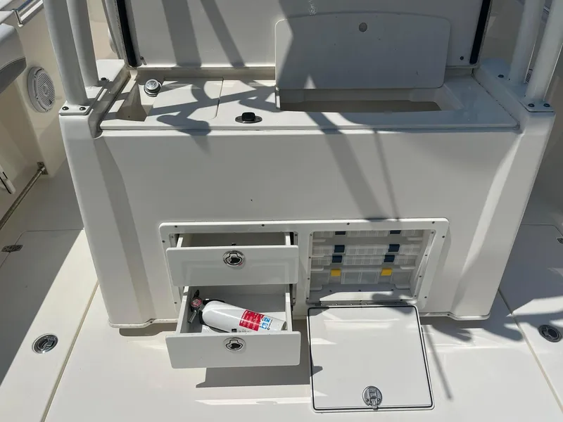 Slide: The Image of 2019 Cobia 320 CC boat storage area with open drawers and compartments. - 16