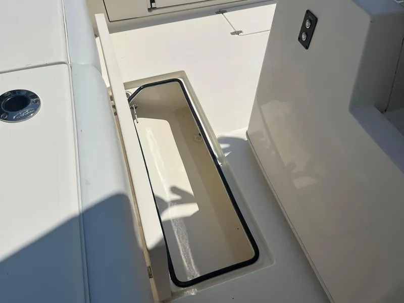 Slide: The Image of Open storage compartment on 2019 Cobia 320 CC boat deck. - 18