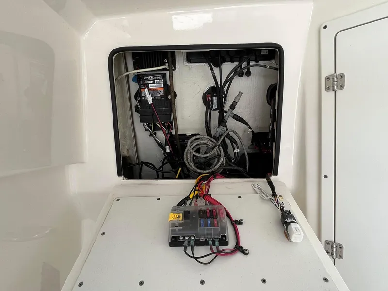 Slide: The Image of 2019 Cobia 320 CC boat electrical panel with wiring and components. - 31