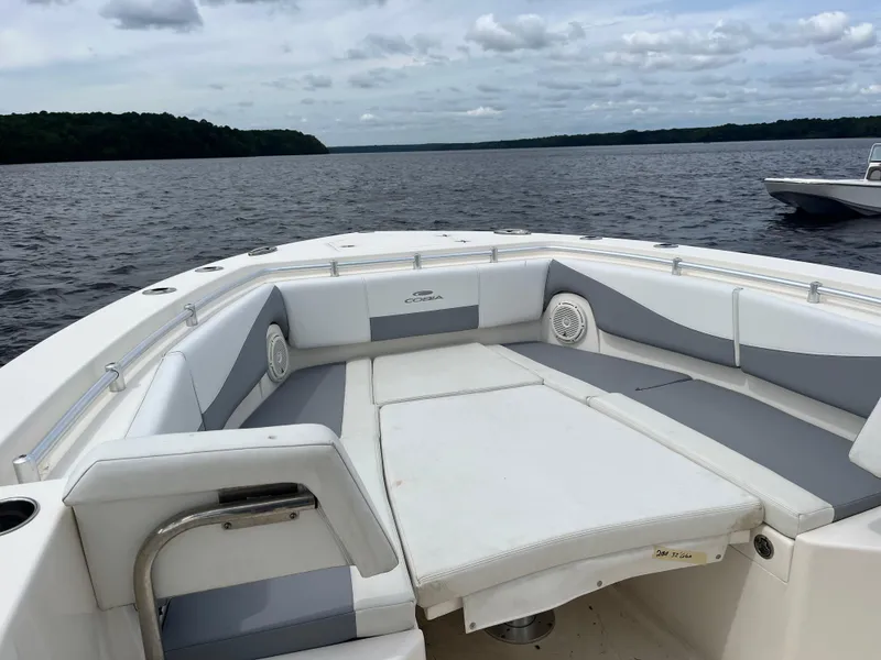 Slide: The Image of 2019 Cobia 320 CC boat with spacious seating on a calm lake. - 35