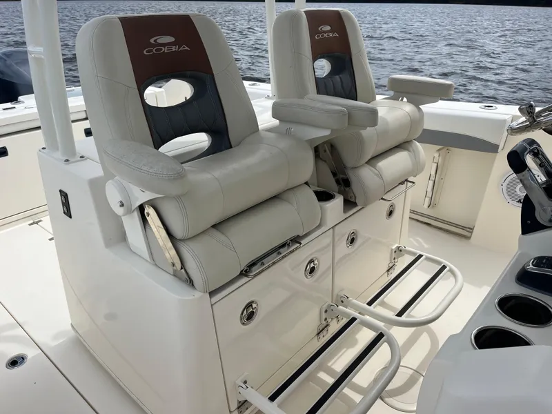 Slide: The Image of 2019 Cobia 320 CC boat with luxurious seating and storage on deck. - 38