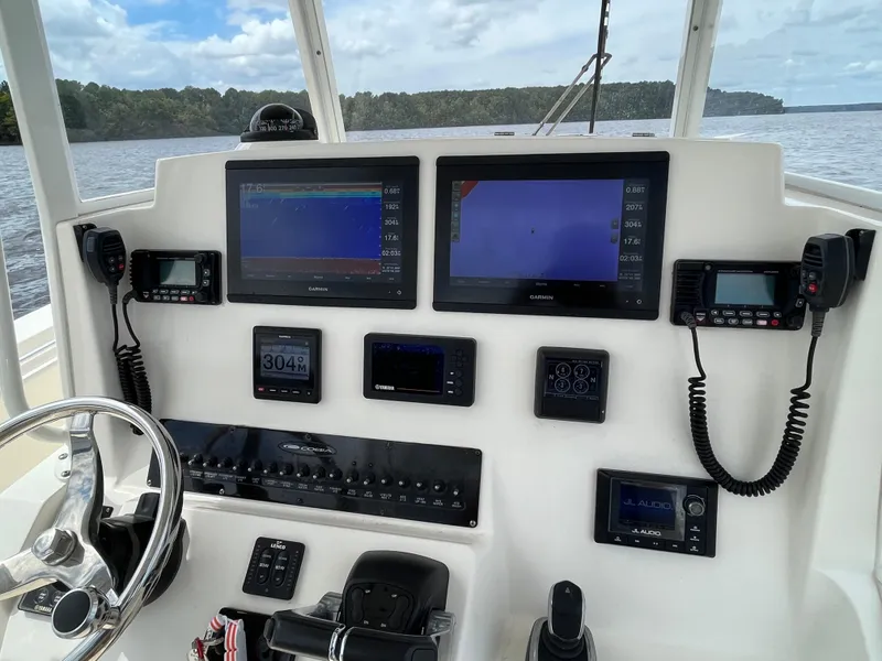Slide: The Image of Helm of 2019 Cobia 320 CC boat with navigation screens and controls. - 42