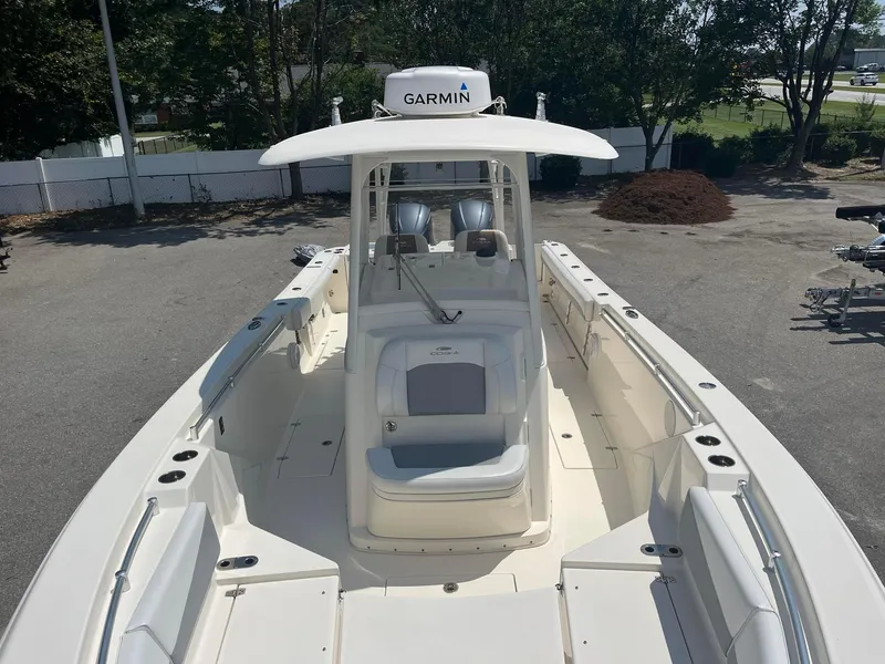 Slide: The Image of 2019 Cobia 320 CC boat with Garmin equipment, spacious deck, and seating. - 9