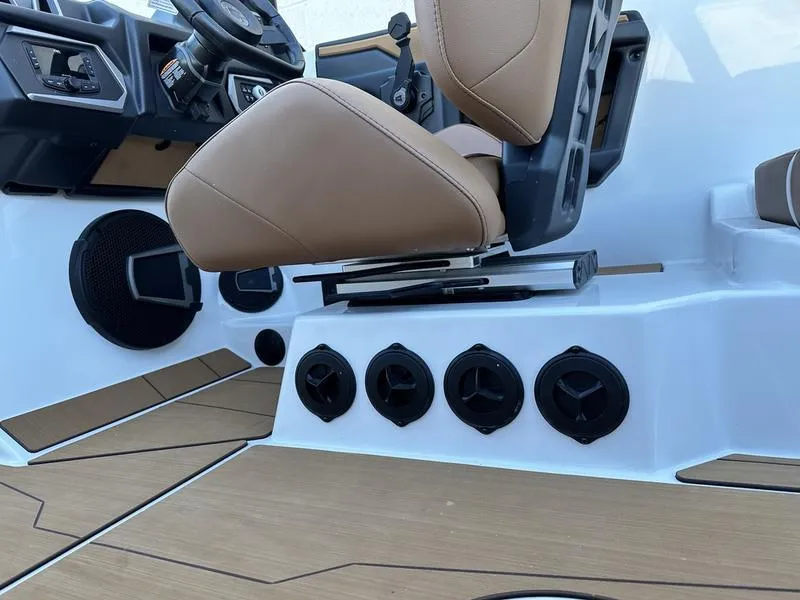 Slide: The Image of 2024 Axis T250 boat interior with tan seats and multiple cup holders. - 11