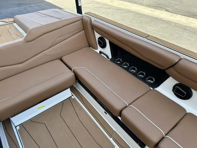 Slide: The Image of 2024 Axis T250 boat interior with brown leather seating and cup holders. - 12