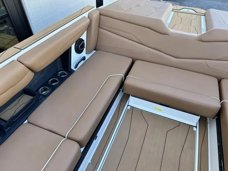 Slide: The Image of 2024 Axis T250 boat interior with tan leather seats and cup holders. - 13