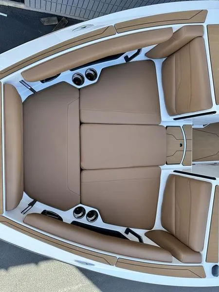 Slide: The Image of 2024 Axis T250 boat with tan leather seating and cup holders. - 14