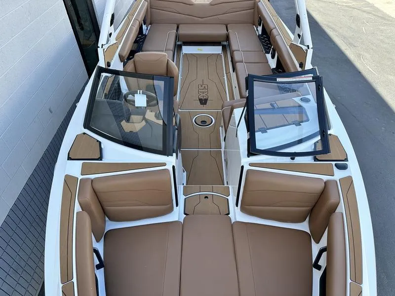 Slide: The Image of 2024 Axis T250 boat interior with tan leather seats and open windshield. - 15