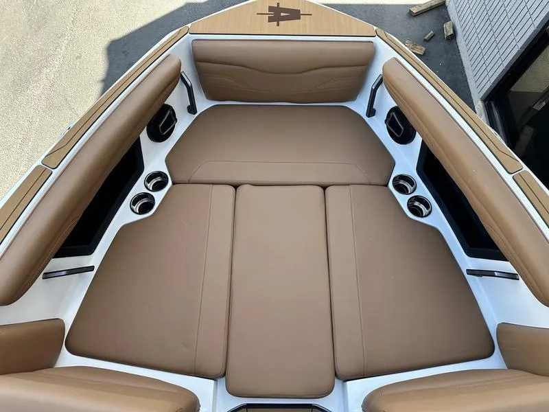Slide: The Image of 2024 Axis T250 boat with tan cushioned seating in the bow area. - 16