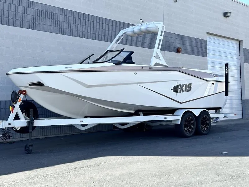 Slide: The Image of 2024 Axis T250 boat on trailer outside industrial building. - 18