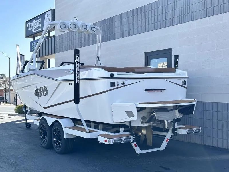 Slide: The Image of 2024 Axis T250 boat on trailer outside dealership. - 5