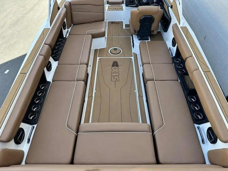 Slide: The Image of 2024 Axis T250 boat interior with tan seating and ample cup holders. - 7