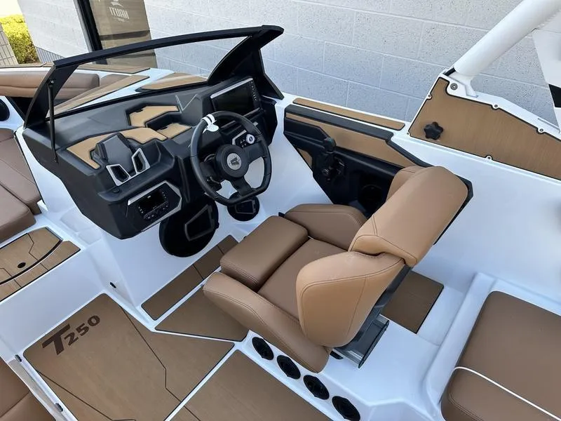 Slide: The Image of 2024 Axis T250 boat interior with tan seats and modern dashboard. - 8