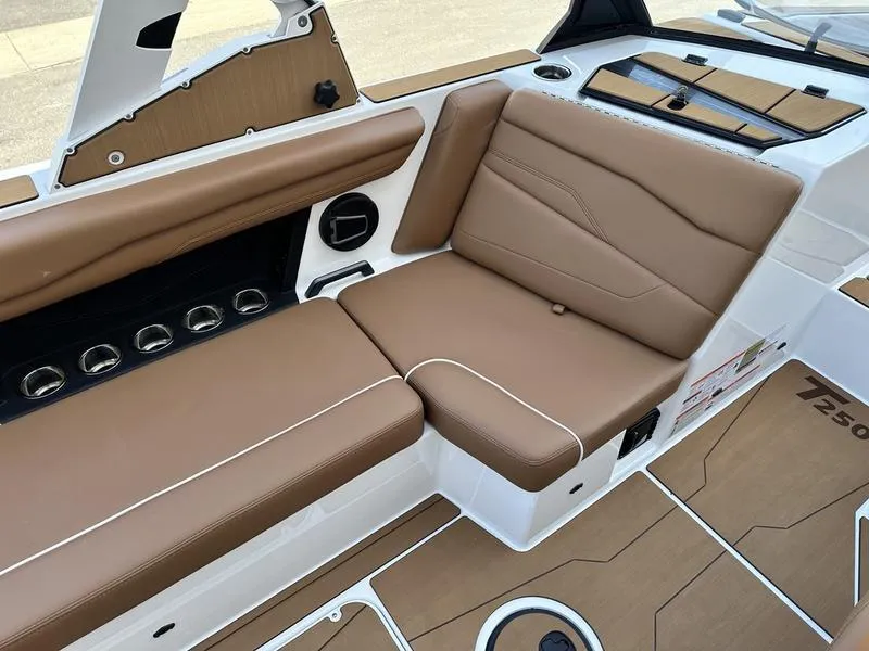 Slide: The Image of 2024 Axis T250 boat interior with brown leather seating and white accents. - 9