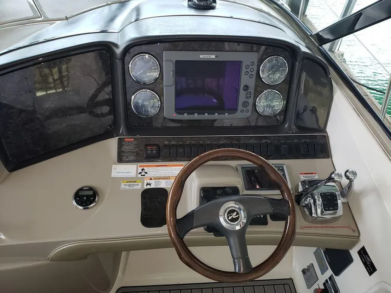 Slide: The Image of 2008 Sea Ray 38 Sundancer helm with steering wheel, gauges, and navigation system. - 15