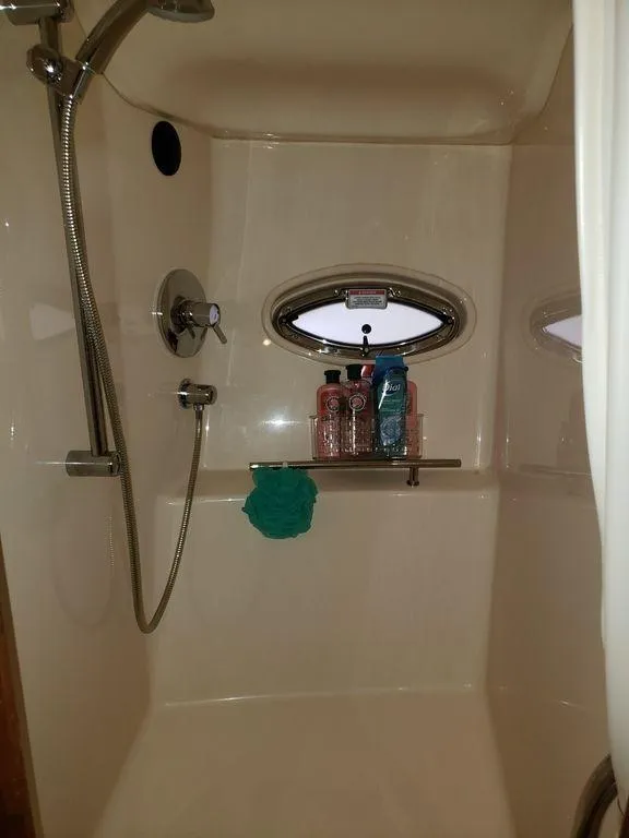 Slide: The Image of Shower area in 2008 Sea Ray 38 Sundancer yacht with window and toiletries. - 18