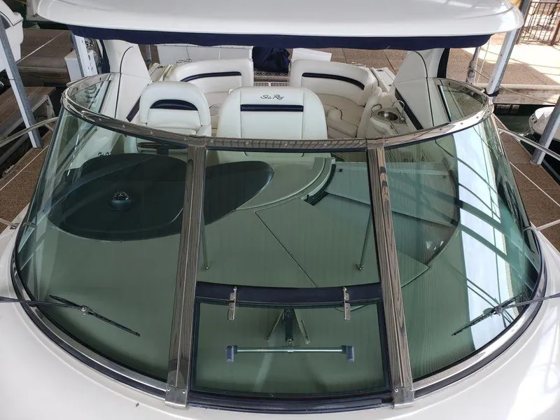 Slide: The Image of 2008 Sea Ray 38 Sundancer boat with spacious cockpit and windshield. - 19