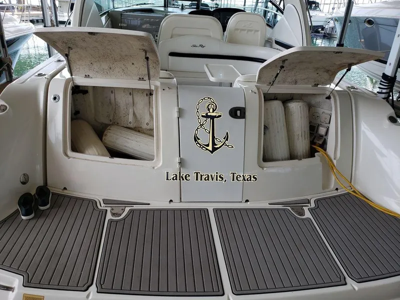 Slide: The Image of 2008 Sea Ray 38 Sundancer boat at Lake Travis, Texas, with open storage compartments. - 20