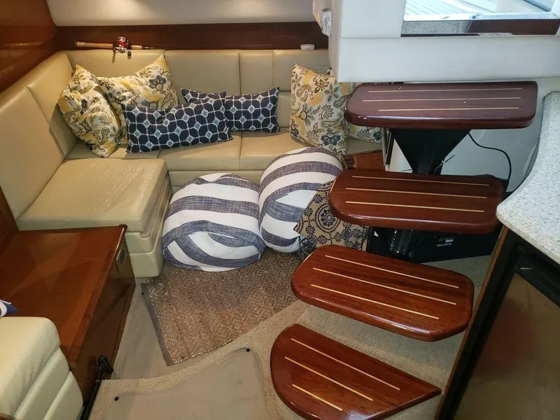 Slide: The Image of Interior of 2008 Sea Ray 38 Sundancer with cozy seating and decorative pillows. - 23