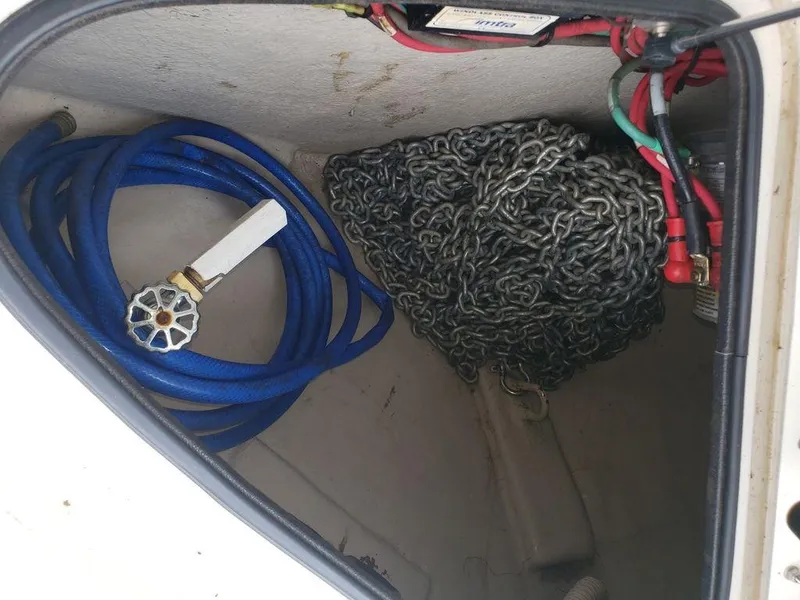 Slide: The Image of Storage compartment of a 2008 Sea Ray 38 Sundancer with hose and anchor chain. - 29
