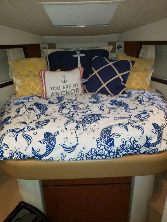 Slide: The Image of 2008 Sea Ray 38 Sundancer cabin with nautical-themed bedding and pillows. - 32