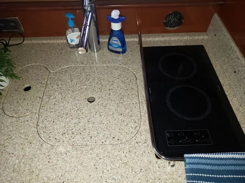 Slide: The Image of Galley kitchen in 2008 Sea Ray 38 Sundancer with electric cooktop and sink. - 38