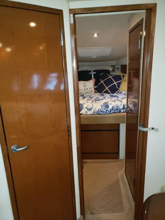 Slide: The Image of Interior cabin of a 2008 Sea Ray 38 Sundancer yacht with wooden doors and cozy bedding. - 41