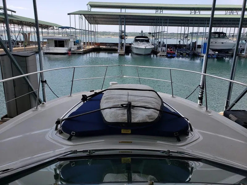 Slide: The Image of 2008 Sea Ray 38 Sundancer docked at a marina with covered slips. - 44