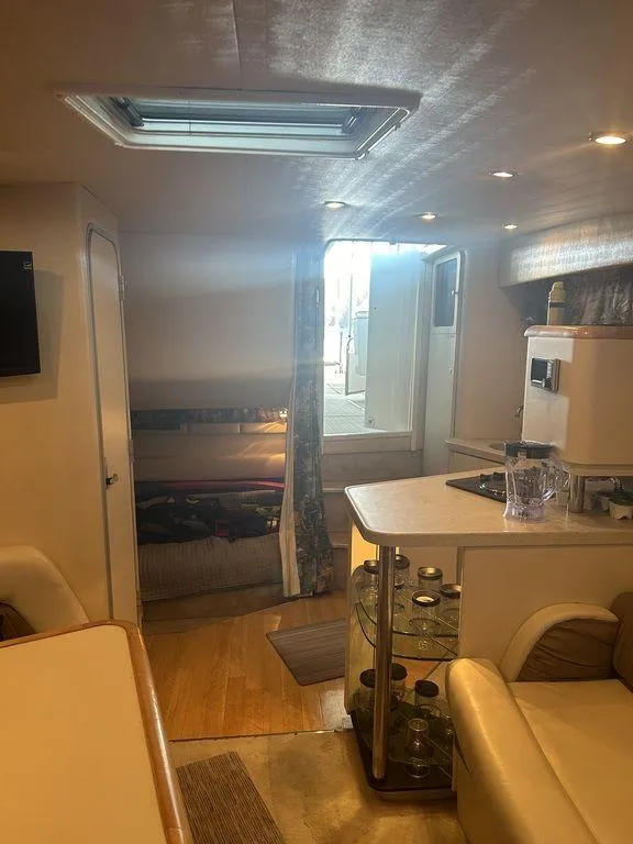 Slide: The Image of Interior of 1997 Wellcraft 3600 Martinique yacht with kitchen and seating area. - 10