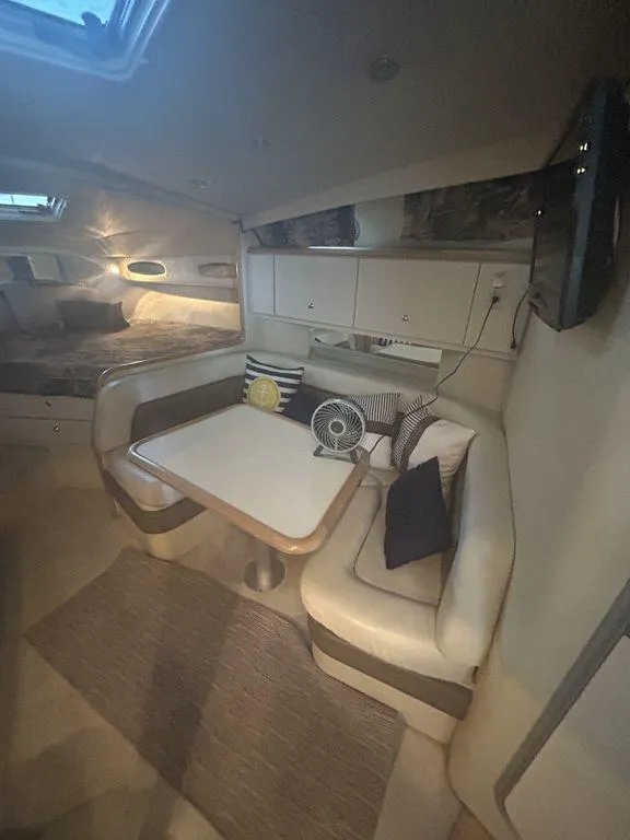 Slide: The Image of 1997 Wellcraft 3600 Martinique cabin interior with dining area and seating. - 17