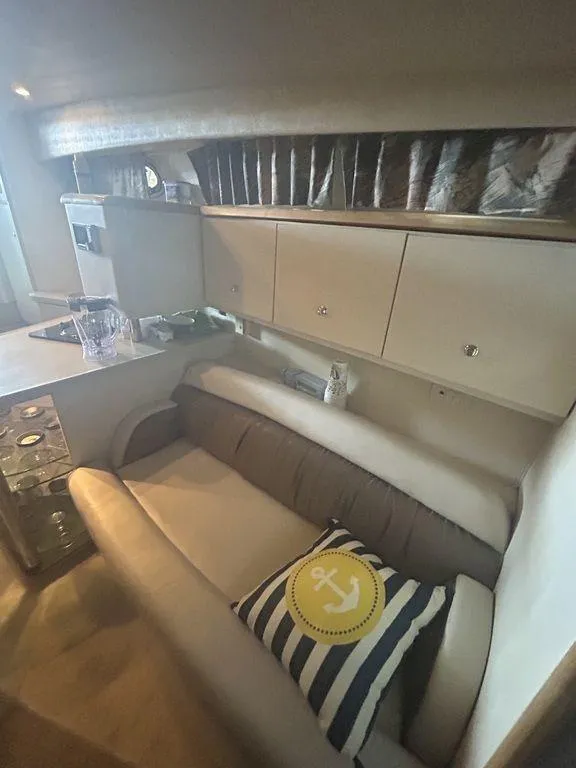 Slide: The Image of Interior of 1997 Wellcraft 3600 Martinique yacht with cozy seating area. - 18