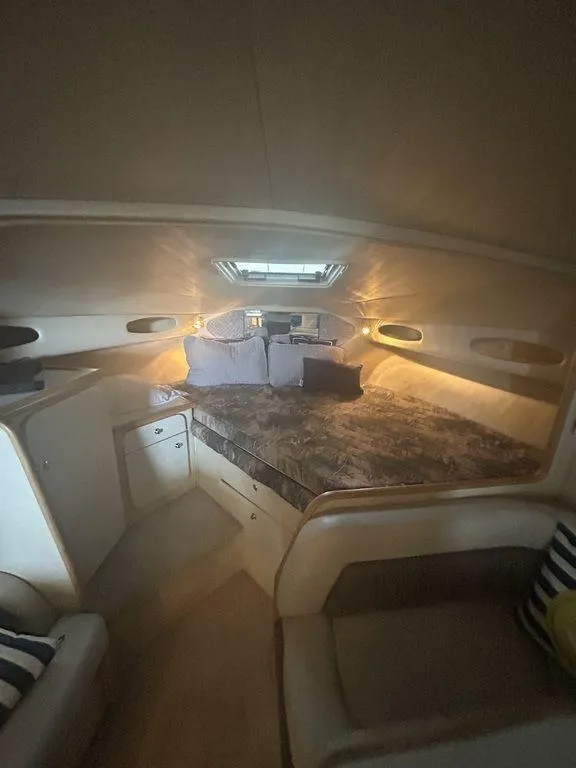 Slide: The Image of 1997 Wellcraft 3600 Martinique cabin interior with bed and seating area. - 19