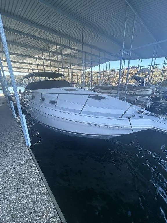 Slide: The Image of 1997 Wellcraft 3600 Martinique boat docked in a covered marina. - 2