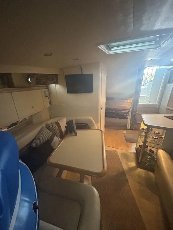 Slide: The Image of Interior of 1997 Wellcraft 3600 Martinique yacht with dining area and TV. - 21