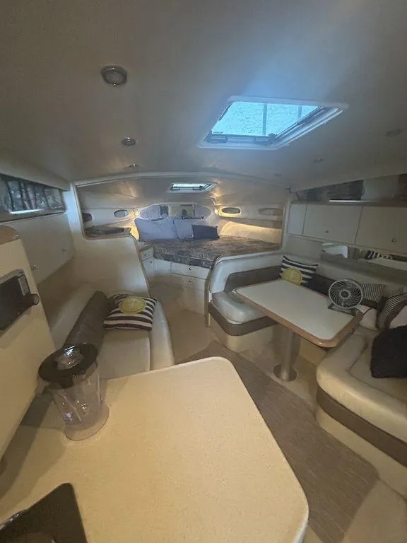 Slide: The Image of Interior of 1997 Wellcraft 3600 Martinique yacht with seating and sleeping areas. - 24