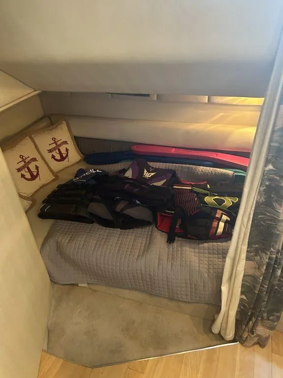 Slide: The Image of 1997 Wellcraft 3600 Martinique cabin interior with bed and life jackets - 25