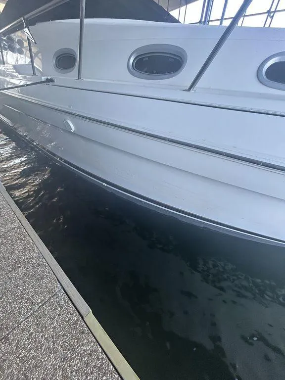 Slide: The Image of 1997 Wellcraft 3600 Martinique boat docked in marina. - 3