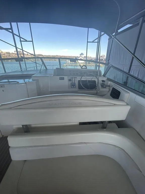 Slide: The Image of 1997 Wellcraft 3600 Martinique yacht cockpit with steering wheel and seating. - 31