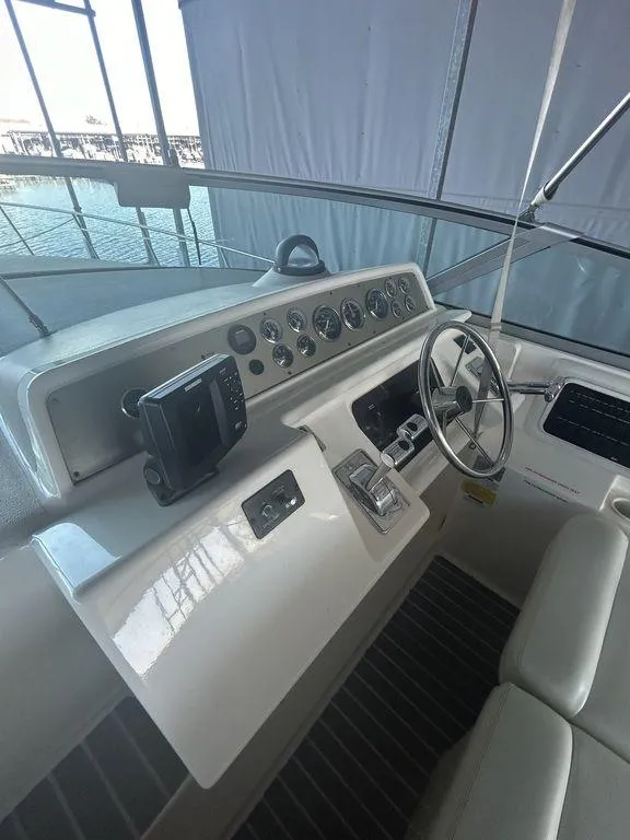 Slide: The Image of 1997 Wellcraft 3600 Martinique boat helm with steering wheel and control panel. - 32