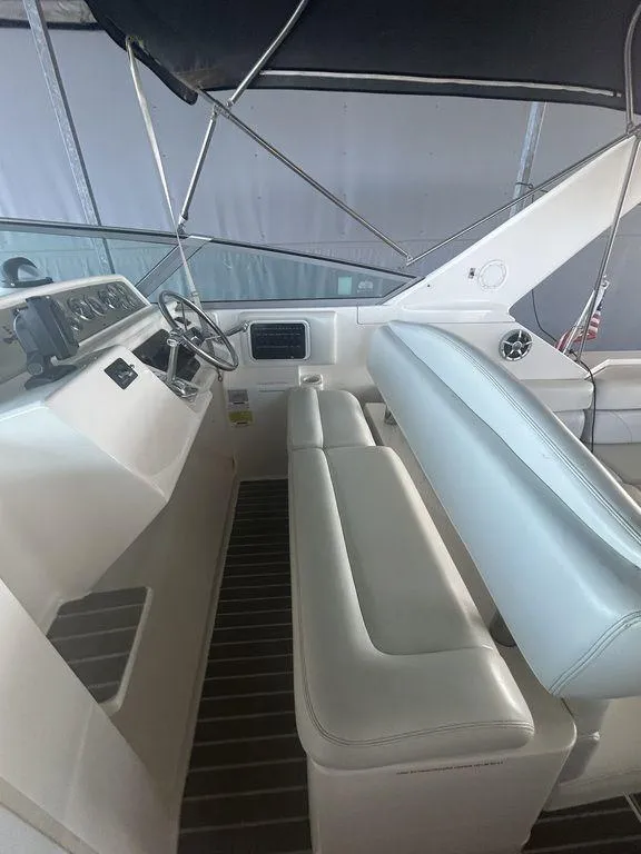 Slide: The Image of 1997 Wellcraft 3600 Martinique boat interior with white seating and steering console. - 33