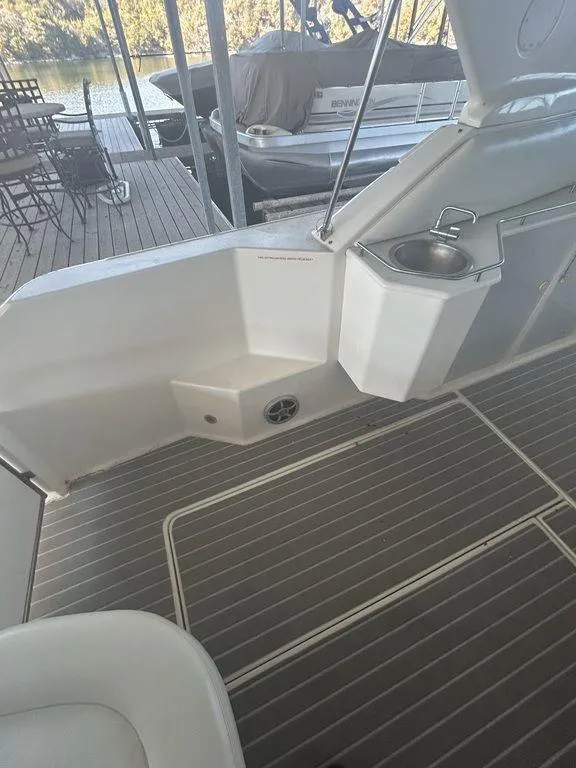 Slide: The Image of 1997 Wellcraft 3600 Martinique boat deck with seating and sink. - 36