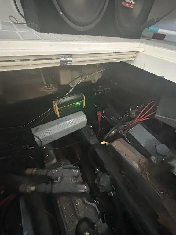 Slide: The Image of Engine compartment of a 1997 Wellcraft 3600 Martinique boat with visible wiring and components. - 39
