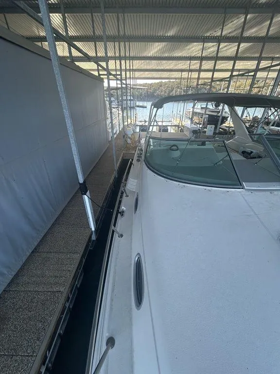 Slide: The Image of 1997 Wellcraft 3600 Martinique docked in a covered marina. - 4
