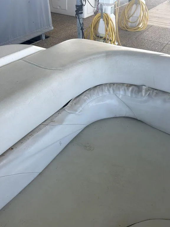 Slide: The Image of 1997 Wellcraft 3600 Martinique boat interior with worn white upholstery. - 40