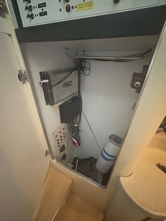 Slide: The Image of Electrical panel and storage compartment in a 1997 Wellcraft 3600 Martinique boat. - 43