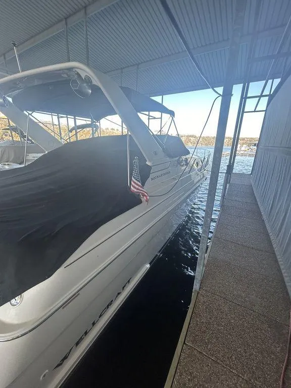 Slide: The Image of 1997 Wellcraft 3600 Martinique docked in a covered marina. - 5