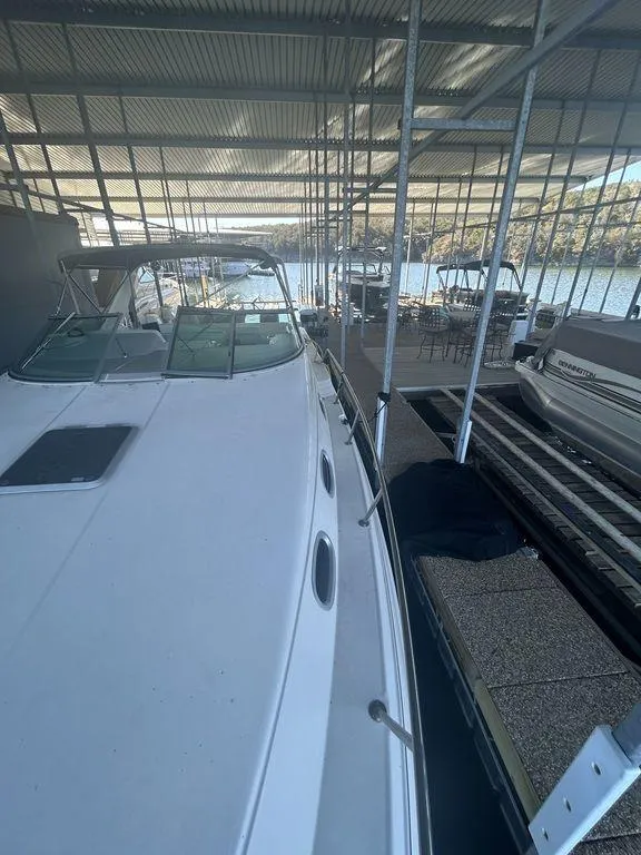 Slide: The Image of 1997 Wellcraft 3600 Martinique docked in a covered marina. - 8