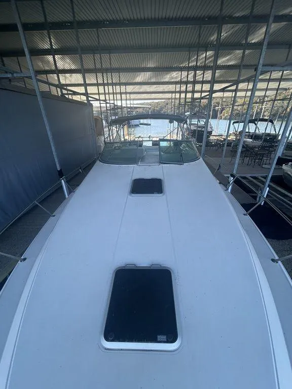 Slide: The Image of 1997 Wellcraft 3600 Martinique boat docked in a covered marina. - 9