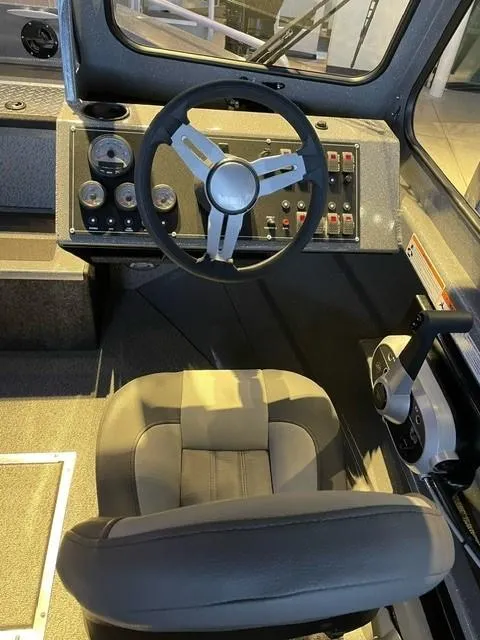 Slide: The Image of 2024 Spartan 185 Astoria boat cockpit with steering wheel and control panel. - 6